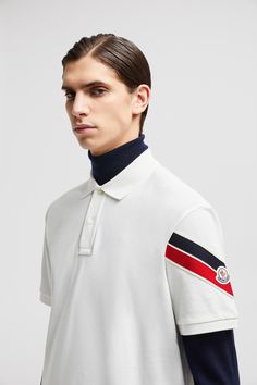 A timeless design that transcends season, this polo shirt is enhanced with a tricolor trim on the sleeve. The top is presented in cotton piquet with short sleeves. Luxury Short Sleeve Polo Shirt With Striped Collar, Luxury Short Sleeve Top With Striped Collar, Designer White Tops With Ribbed Collar, White Collared Top With Signature Stripes, Luxury White Short Sleeve Polo Shirt, Luxury White Polo Shirt With Ribbed Collar, Designer White Polo Shirt, White Collared Polo Shirt With Signature Stripes, Polo Shirt Design Ideas