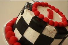 a black and white checkered cake with red beads