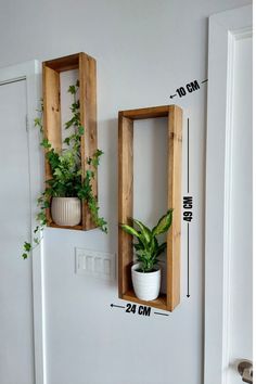 two wooden boxes with plants in them are on the wall next to each other and measurements