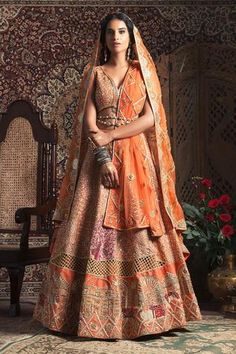 Tangerine lehenga with all-over embroidery. Paired with blouse and two dupattas.
Component: 4
Embroidered
Neckline: V-Neck
Sleeve Length: Sleeveless
Fabric: Raw Silk
Color: Orange
Cut dana, sequin, nakshi, dabka and threadwork embroidery
Embroidered dupattas
Note: Belt worn by the model is not for sale - Aza Fashions Bride And Prejudice, Orange Embroidery, Designer Bridal Lehenga, Moroccan Wedding, Bridal Lehenga Choli, Indian Embroidery, Silk Lehenga, Embroidered Neckline, Indian Fashion Designers