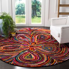 a living room with a chair and rug on the floor