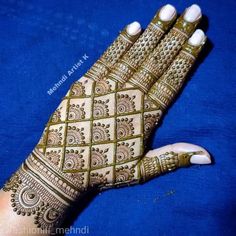 a woman's hand with henna on it