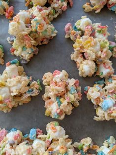 some kind of cereal krispy kreme treats on a baking sheet with sprinkles