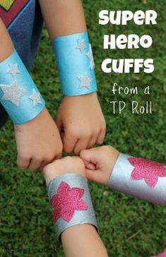 two children holding hands with the words super hero cuffs from a tp roll on them