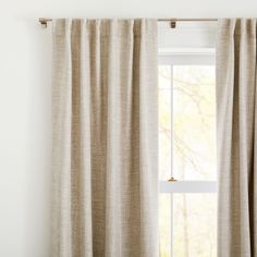 an open window with curtains hanging on the side and a lamp in front of it