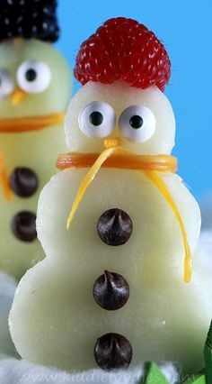 two snowmen made out of candy with googly eyes