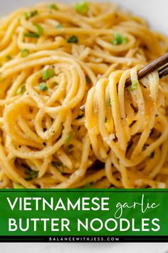 a close up of a plate of noodles with chopsticks in it and text overlay that reads vietnamese garlic butter noodles