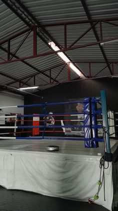 an empty boxing ring with ropes on the ground