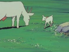 an animal and its baby are walking in the grass