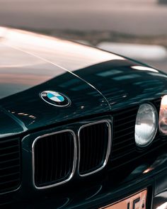 the front end of a black bmw car