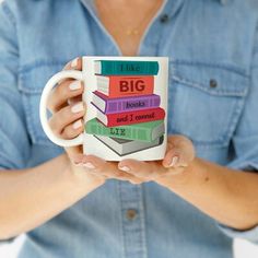 a woman is holding a coffee mug with books on it and the words, i like big books and i cannot lie