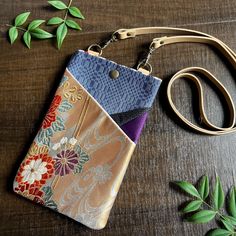 A special, one-of-a-kind item that combines the beauty of Japanese culture with modern convenience. A smartphone case made using beautifully patterned parts selected from precious kimonos and obi. This piece respects the traditional Japanese kimono while at the same time being designed to fit into modern life. This smartphone case is a unique and rare item, and its beauty will surely catch the eye of others. By decorating the smartphone that everyone owns with traditional Japanese patterns, you can feel the charm of Japanese culture in your everyday life. What's more, this smartphone case is convenient enough to be carried with you at all times. It's easy to reach, protects your smartphone, and doesn't compromise on design, giving you the feeling of wearing Japanese beauty on your person. Multicolor Phone Bag With Cell Phone Pocket As Gift, Rectangular Pouch With Cell Phone Pocket As Gift, Handmade Multicolor Phone Bag For Gift, Rectangular Pouch With Cell Phone Pocket For Gift, Gold Rectangular Phone Bag Gift, Rectangular Phone Bag With Cell Phone Pocket As Gift, Multicolor Pouch With Cell Phone Pocket For Gift, Smartphone Pouch, Buffet Party