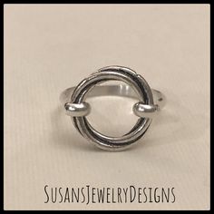 This ring is made with a sterling silver open circle that has a really neat design that twists as it goes around. Sterling silver wire has been added to make up the band of the ring. This ring is super comfortable to wear. Use the options pull down menu to select your ring size. Comes wrapped and ready to gift if needed. To see my other rings, click here: https://www.etsy.com/shop/SusansJewelryDesigns?ref=seller-platform-mcnav&section_id=7658693 Adjustable Round Jewelry With Modern Twist, Adjustable Round Jewelry With A Modern Twist, Adjustable Round Modern Twist Jewelry, Minimalist Adjustable Bypass Ring, Modern Twist Sterling Silver Open Ring Jewelry, Minimalist Sterling Silver Wire Wrapped Rings, Modern Twist Open Ring In Sterling Silver, Adjustable Stackable Rings With A Modern Twist, Sterling Silver Jewelry With Ring Detail, Modern Twist