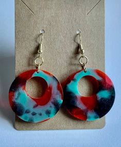 Handmade resin earrings that are lightweight and hang about 1 inch from the ear. Nickel-free Round Resin Earrings, Trendy Resin Drop Earrings, Trendy Red Resin Earrings, Trendy Red Hand Painted Earrings, Multicolor Plastic Earrings As Gift, Red Plastic Earrings For Gift, Green Plastic Earrings For Gifts, Unique Resin Dangle Earrings, Hand Painted Resin Drop Earrings