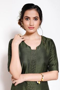 Olive green kurta with embellishments on placket and asymmetric hem. Paired with palazzo.
Components: 2
Pattern: Embellished
Type Of Work: Floral
Neckline: Round
Sleeve Type: Half
Fabric: Crepe, silk
Color: Green
Other Details: 
Embellished Placket
Asymmetric hem
Attached lining
Occasion: Puja - Aza Fashions Elegant Green Kurta With Mirror Work, Green Straight Kurta Sets With Embroidered Neckline, Green Blouse With Embroidered Neckline, Elegant Green Top With Resham Embroidery, Festive Green Kurta With Embroidered Neckline, Green Sets With Embroidered Neckline, Green Straight Kurta Blouse, Elegant Green Embellished Tops, Elegant Green Tops For Festive Occasions