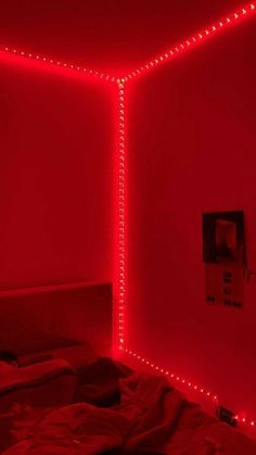 a bed with red lights in a room