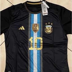 a soccer jersey with the number 10 on it is hanging from a hanger in front of a tile wall