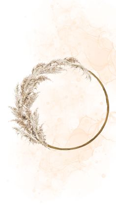 a circular frame with dried grass in the middle on a white background, surrounded by watercolor stains