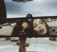 two women are seen in the rear view mirror