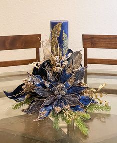 a blue vase sitting on top of a glass table