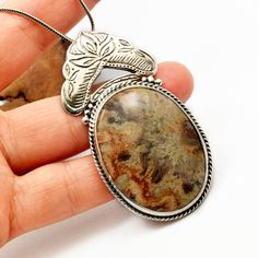 "Crazy lace agate necklace sterling silver large oval lace agate pendant orange brown beige antique bohemian style, artisan boho jewelry A beautiful large oval crazy lace agate stone with hues of brown, beige and orange in sterling silver statement pendant. Lovely autumn colors and winter colors too. The stone is set inside a bezel and framed with braided wire . On top of it there is an engraved antique floral pattern. I have oxidized it to bring out the details and achieved this bohemian look T Contemporary Handmade Jewelry, Antique Floral, Agate Necklace, Statement Pendant, Autumn Colors, Crazy Lace Agate, Agate Pendant, Winter Colors, Lace Agate