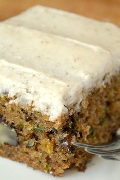 a close up of a piece of cake on a plate with a fork in it