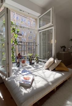 a bed sitting next to a window in a bedroom