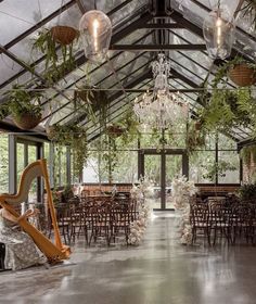 the inside of a building with tables, chairs and chandeliers hanging from the ceiling