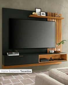 a flat screen tv mounted to the side of a wooden entertainment center in a living room