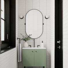 a bathroom with a sink, mirror and green cabinet in the corner next to it