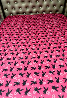 a pink bed with black and white designs on it