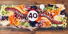 a birthday cake made out of fruits and vegetables with the number forty written on it