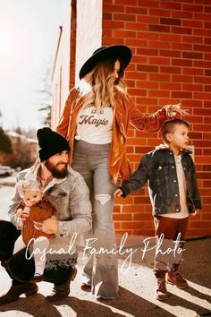 a woman and two children holding hands in front of a brick wall with the words family photos