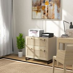 a room with a desk, chair and painting on the wall above it that has a white rug in front of it