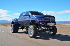 a large blue truck driving down the road