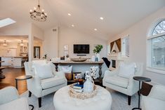 a living room filled with furniture and a flat screen tv mounted to the side of a wall