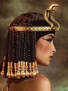 an egyptian woman with long braids and a snake on her head