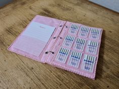 an open pink binder on top of a wooden table