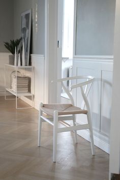 a white chair sitting on top of a hard wood floor