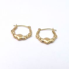 two small gold hoop earrings on a white background, one is shaped like a crab and the other is shaped like a frog