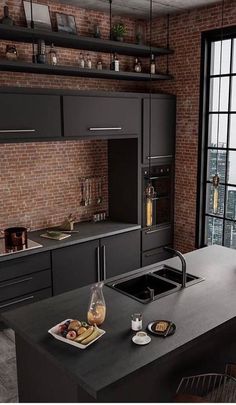 a modern kitchen with black cabinets and an island in front of a window overlooking the city