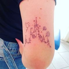 a woman with a tattoo on her arm that has a castle and fireworks in it