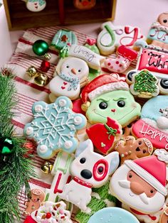 decorated christmas cookies are displayed on a table