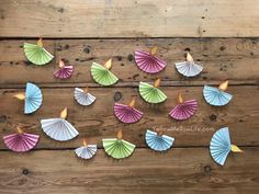 colorful paper fans arranged on wooden planks