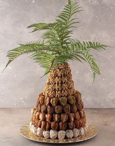 a pineapple is stacked with nuts and leaves