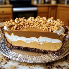 a pie sitting on top of a metal pan covered in frosting and toppings