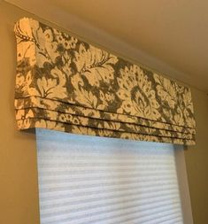 a window with a valance that has a flower pattern on the top and bottom