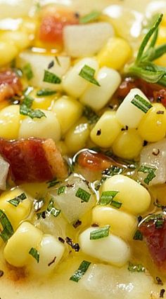 a close up of a plate of food with corn on the cob and cheese