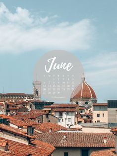 a calendar with the word june on it in front of rooftops and old buildings