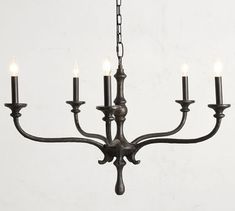 a chandelier with five candles hanging from it